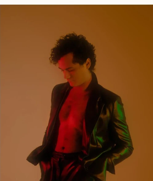 Alejandro Molinari portrait in warm amber and red light from his previous website
